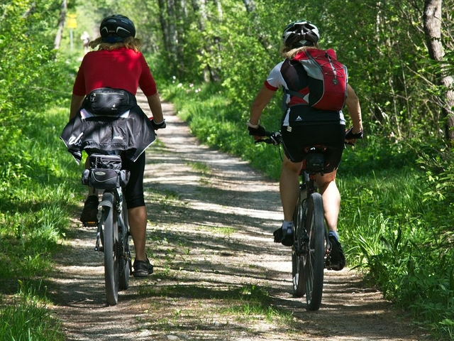 two bicycles and riders in countryside lane